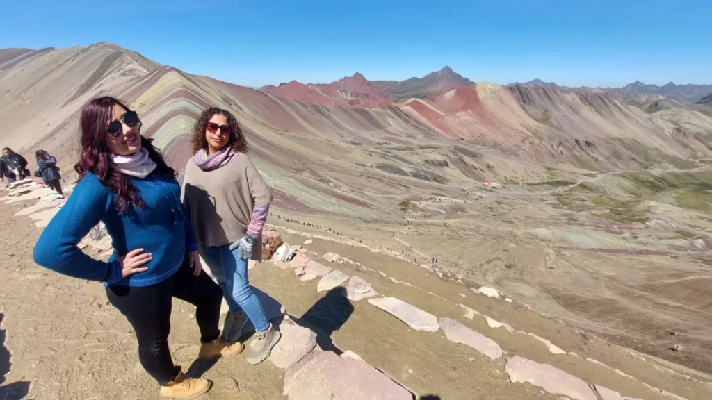 Tourists posing next to the stunning seven-colored mountains